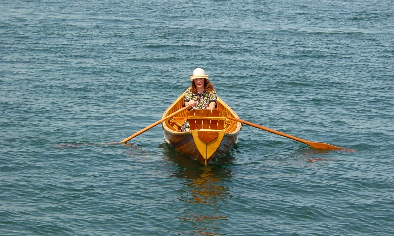 Skylark rowing canoe, Stern view, Lady in 1920's dress out in Clayton New York
